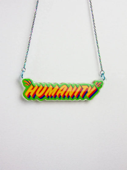 Necklace with 'HUMANITY' pendant on a white background by UK artist, Stoofy. Designed by Stoofy. Copyright Stoofy. 