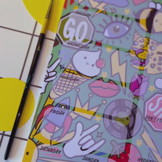 Video of a4 desk planner by the Stoofy store. Fun. Dopamine. Stationary lover. ADHD planner. Illustrated pattern including: suns, leopards, records, hearts, ice cream, crown, peace hand sign, lips, rocket, moon, strawberry, rose, cloud, four leaf clover, stop sign, go sign, eye, bumble bee, lightning, camera, chocolate. Close up details. Design and copyright owned by Stoofy.