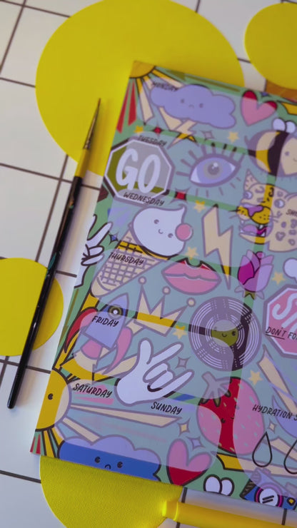 Video of a4 desk planner by the Stoofy store. Fun. Dopamine. Stationary lover. ADHD planner. Illustrated pattern including: suns, leopards, records, hearts, ice cream, crown, peace hand sign, lips, rocket, moon, strawberry, rose, cloud, four leaf clover, stop sign, go sign, eye, bumble bee, lightning, camera, chocolate. Close up details. Design and copyright owned by Stoofy.