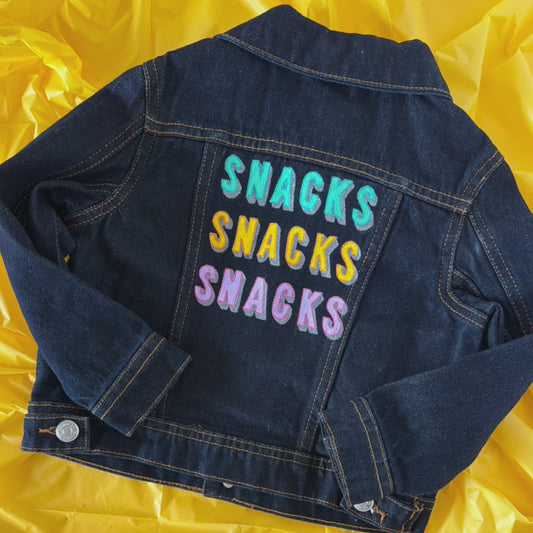 Video stop motion of Stoofy's hand-painted SNACKS SNACKS SNACKS toddler's denim jacket. One of one, limited edition. Unique children's apparel. Design and copyright owned by Stoofy.